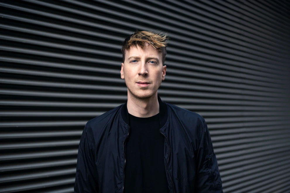 Marc Engelmann vor einer dunklen Metallfassade